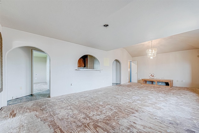 unfurnished living room with a notable chandelier