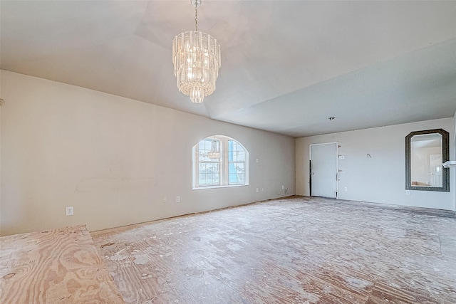 spare room with a chandelier