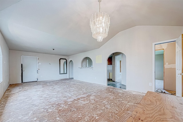 unfurnished bedroom featuring a notable chandelier and lofted ceiling