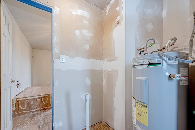 utility room featuring water heater