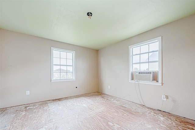 spare room featuring a wealth of natural light and cooling unit