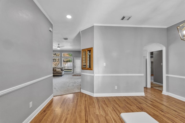 unfurnished room with hardwood / wood-style flooring, ceiling fan, and crown molding