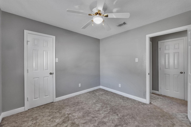 spare room featuring ceiling fan and light colored carpet