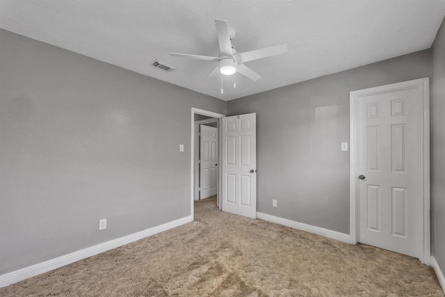 unfurnished bedroom featuring ceiling fan and light carpet