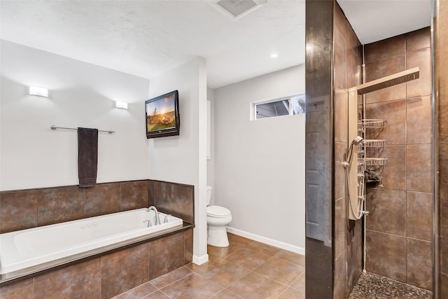 bathroom featuring toilet, tile patterned floors, and plus walk in shower