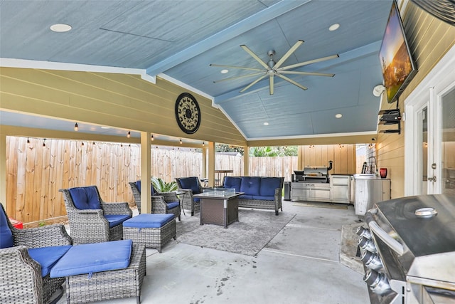 view of patio featuring ceiling fan, area for grilling, and an outdoor living space with a fire pit