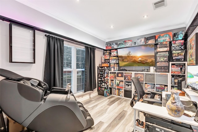 home office with light wood-type flooring and crown molding