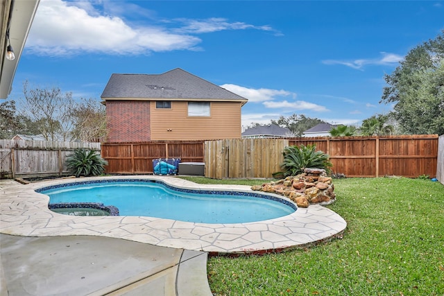 view of swimming pool with a patio and a yard