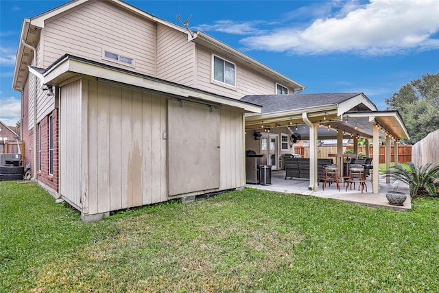 back of house with a lawn, an outdoor hangout area, and a patio