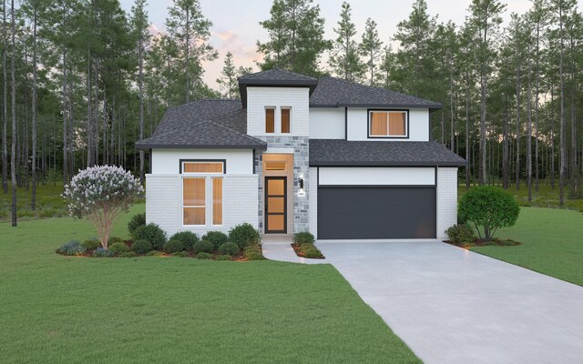 contemporary home featuring a garage and a lawn