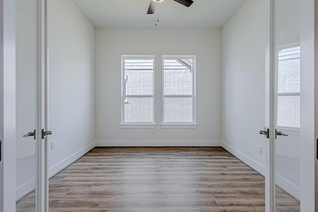 unfurnished room featuring ceiling fan and light hardwood / wood-style floors