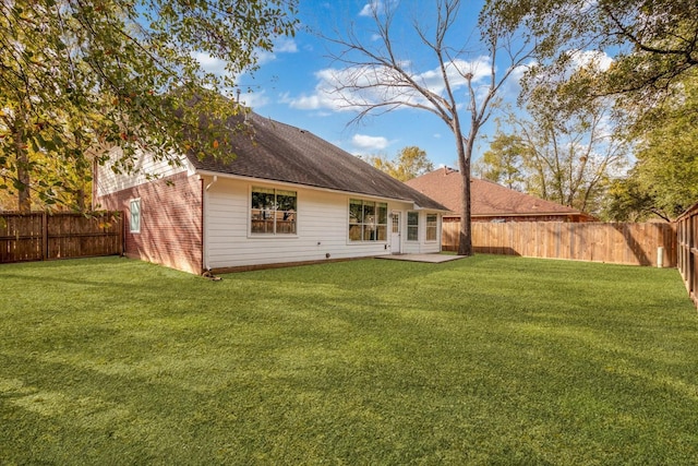 back of house with a lawn