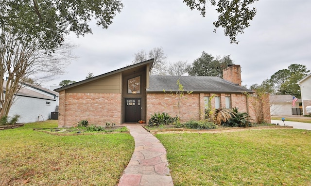 view of front facade with cooling unit and a front lawn