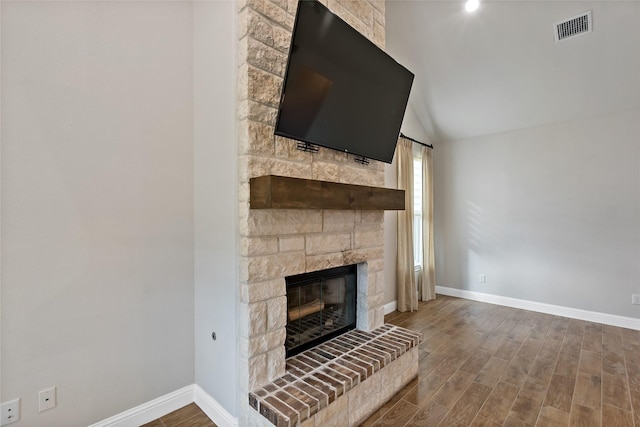 unfurnished living room with vaulted ceiling and a fireplace