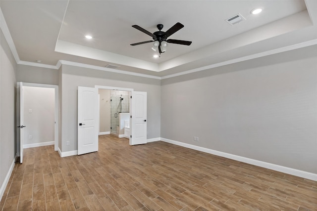 unfurnished bedroom with ceiling fan, a tray ceiling, and crown molding