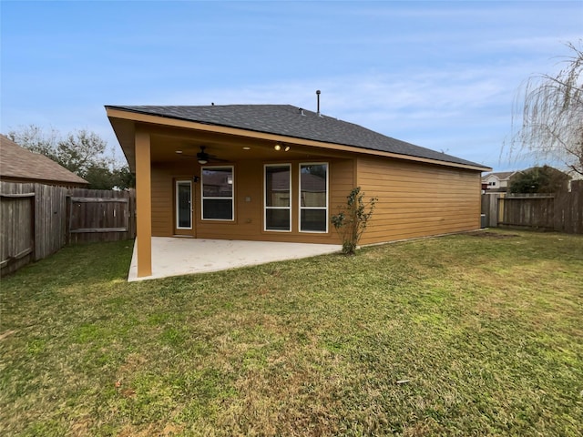 back of house featuring ceiling fan, a patio, and a lawn