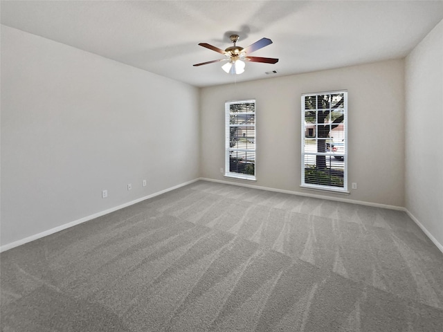 carpeted spare room featuring ceiling fan