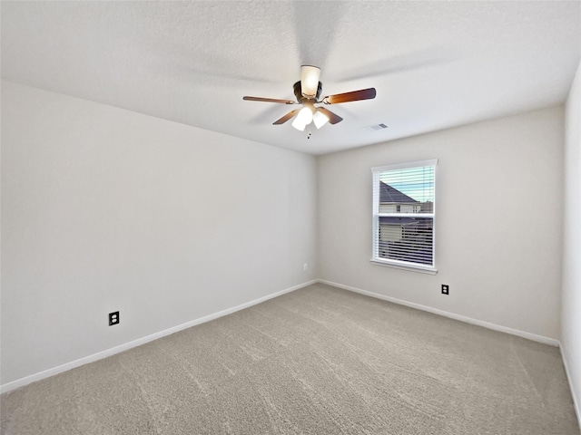 carpeted empty room featuring a textured ceiling and ceiling fan