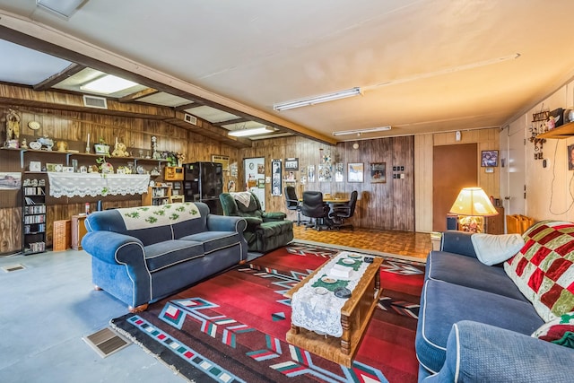 living room with wood walls and concrete flooring