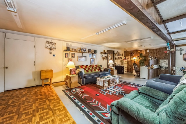 living room with parquet flooring and wooden walls