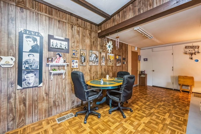 office with parquet floors, beamed ceiling, and wooden walls