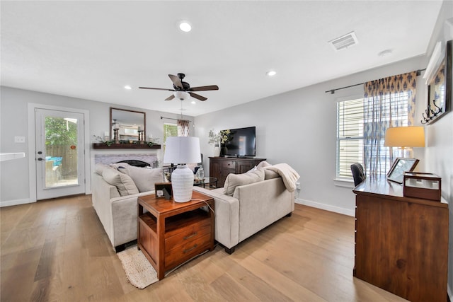 living room featuring ceiling fan and light wood-type flooring