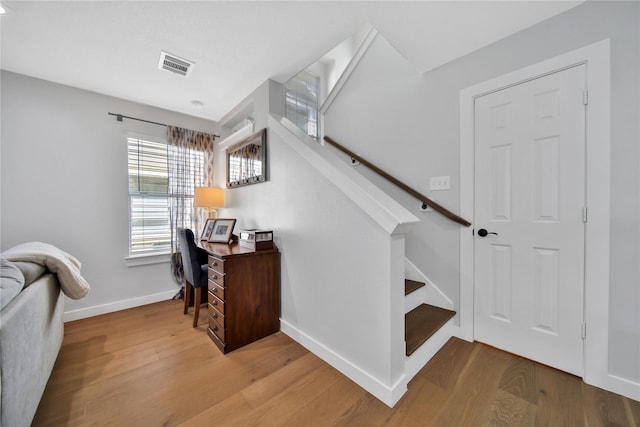 stairway with hardwood / wood-style flooring