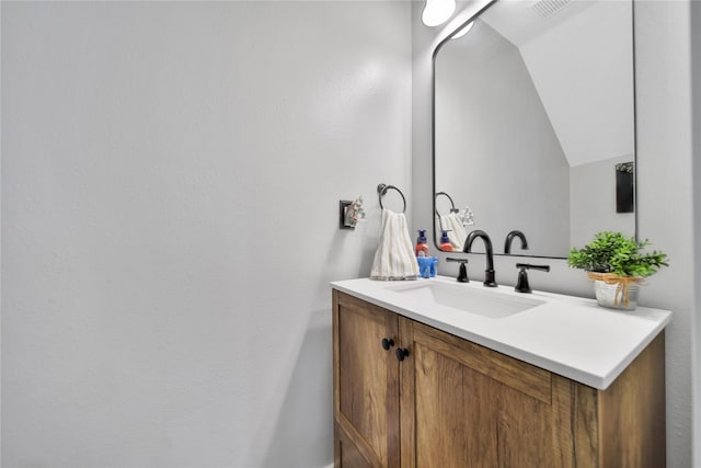 bathroom featuring vanity and vaulted ceiling