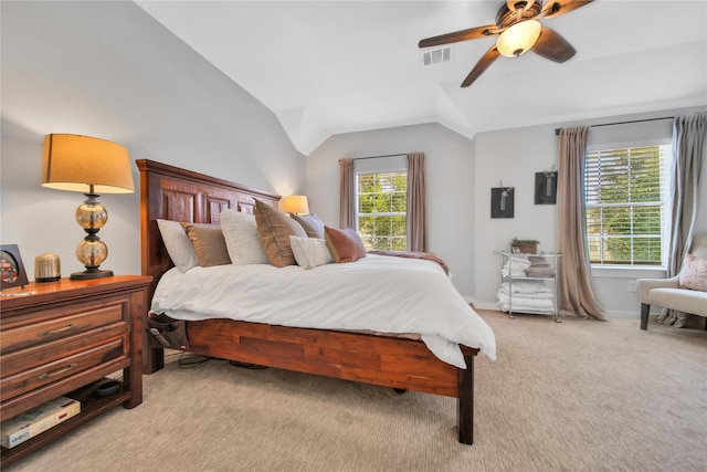 bedroom featuring vaulted ceiling, ceiling fan, light colored carpet, and multiple windows