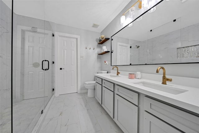 bathroom with a shower with shower door, vanity, and toilet