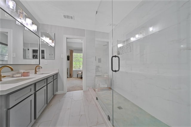 bathroom featuring a shower with shower door and vanity