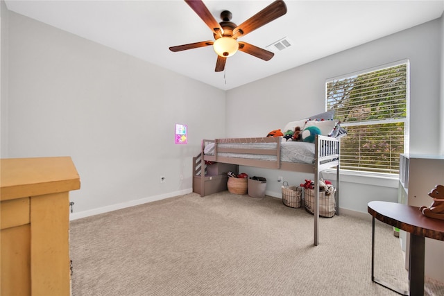 carpeted bedroom with ceiling fan and multiple windows