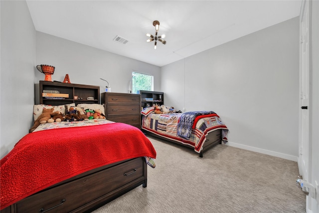 bedroom with light colored carpet and a chandelier