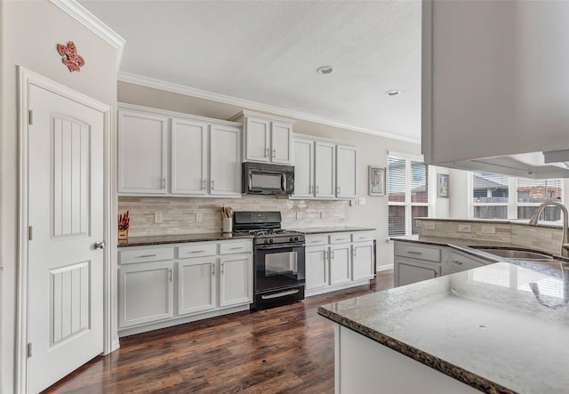 kitchen with black appliances, white cabinets, dark wood-type flooring, and sink