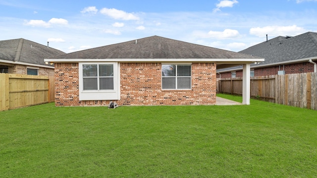 rear view of property with a lawn