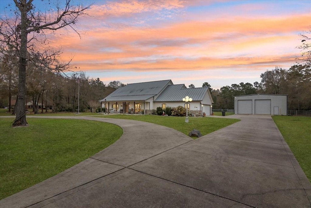 view of front of house with an outbuilding, a yard, and a garage