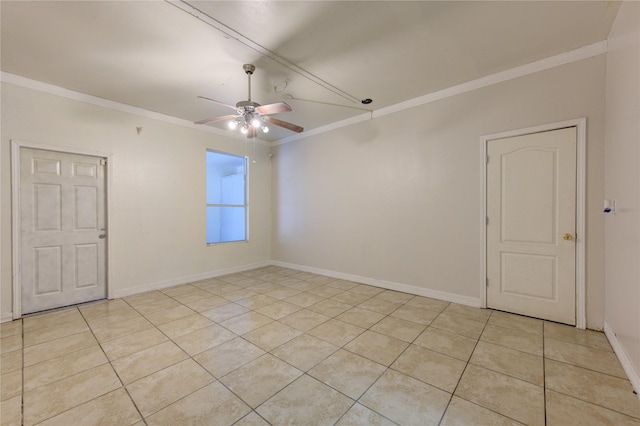 spare room featuring light tile patterned floors, baseboards, a ceiling fan, and crown molding