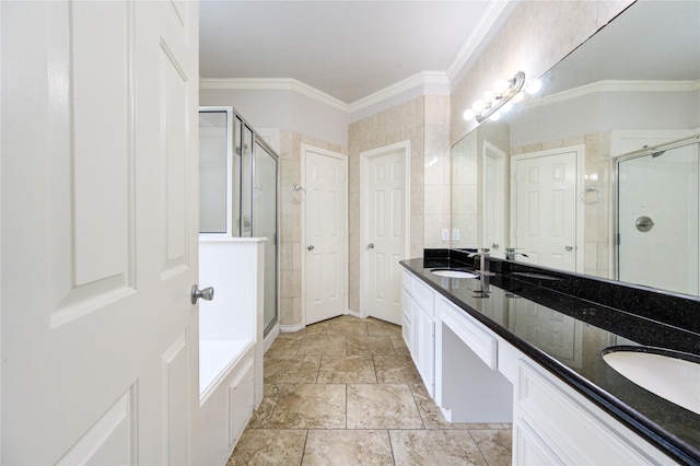 bathroom featuring double vanity, a stall shower, a sink, and crown molding