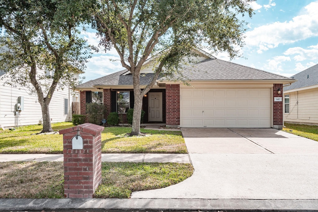 single story home with a front lawn and a garage