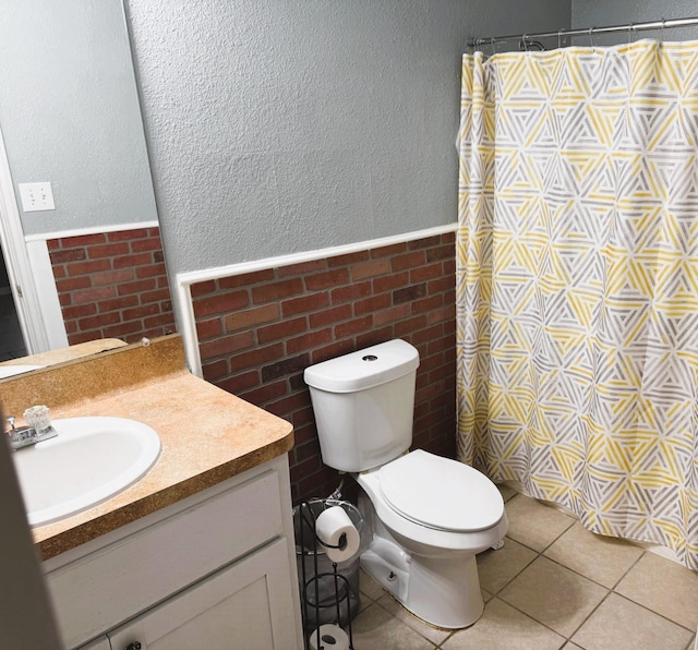 bathroom with toilet, vanity, tile patterned flooring, and a shower with curtain