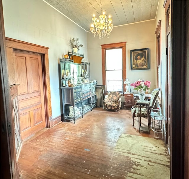 miscellaneous room with ornamental molding, hardwood / wood-style flooring, and a notable chandelier