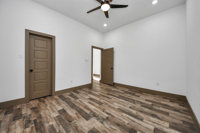 spare room with dark hardwood / wood-style floors and ceiling fan