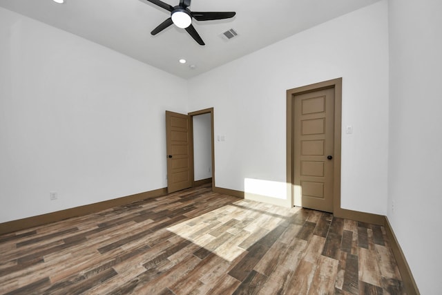 empty room featuring ceiling fan and dark hardwood / wood-style flooring