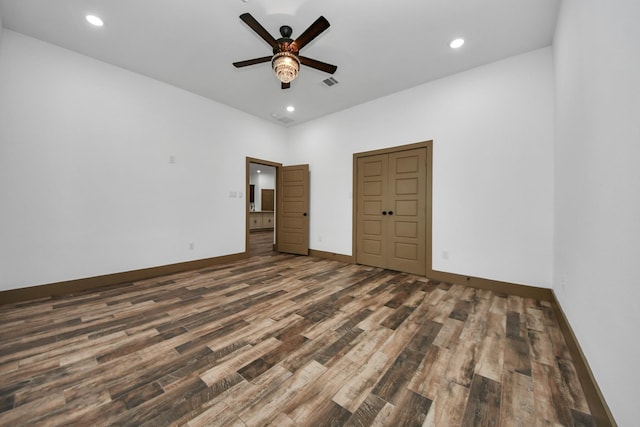 unfurnished bedroom with dark wood-type flooring and ceiling fan