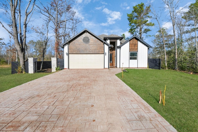 view of front of property with a garage and a front yard