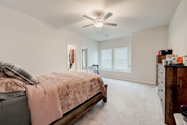 carpeted bedroom featuring a spacious closet, ceiling fan, and a closet