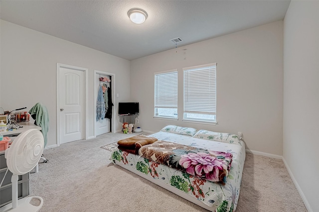 bedroom featuring light carpet