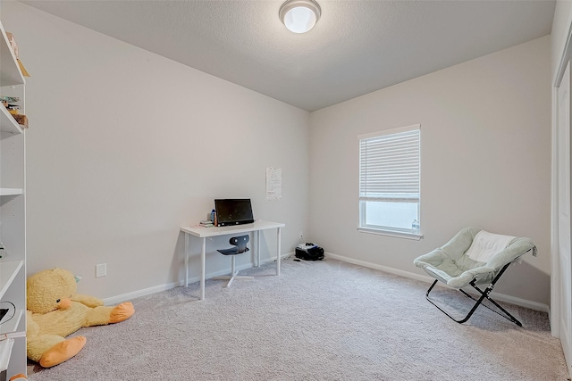 home office featuring a textured ceiling and light colored carpet