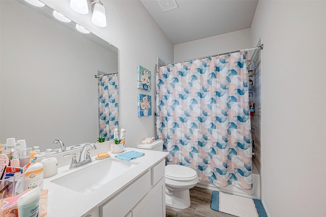 full bathroom featuring hardwood / wood-style flooring, toilet, vanity, and shower / bathtub combination with curtain