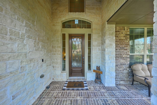 entrance to property with brick siding and stone siding